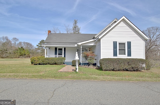 view of front facade with covered porch and a front yard