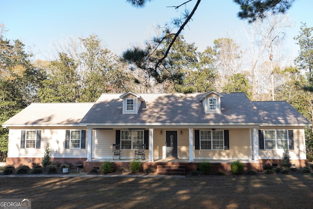 new england style home with covered porch