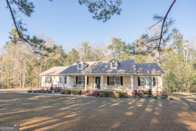 cape cod-style house with a front lawn and a porch