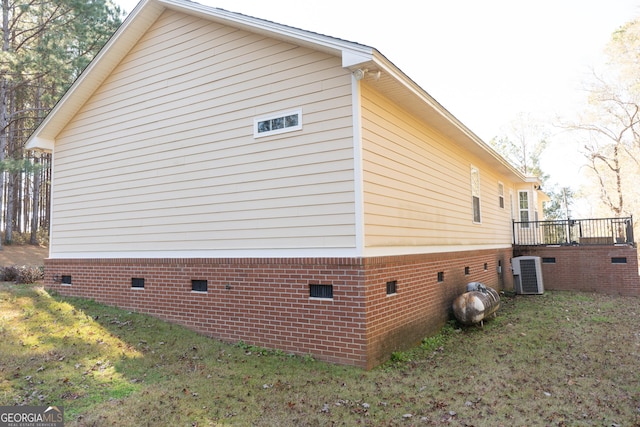 view of property exterior featuring central AC unit and a yard