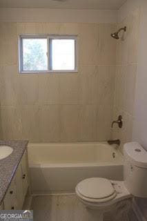 full bath featuring toilet, shower / washtub combination, and vanity