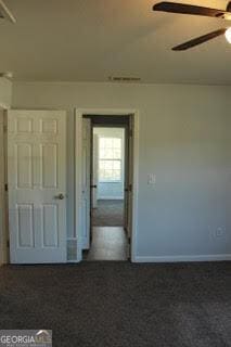 interior space featuring ceiling fan, visible vents, and baseboards