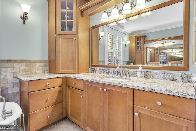 bathroom featuring tile walls, vanity, and crown molding