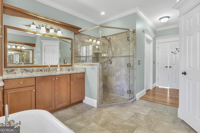 bathroom with ornamental molding, vanity, and an enclosed shower