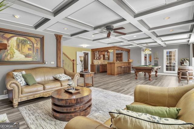 living room featuring light hardwood / wood-style flooring, billiards, beamed ceiling, coffered ceiling, and ornate columns