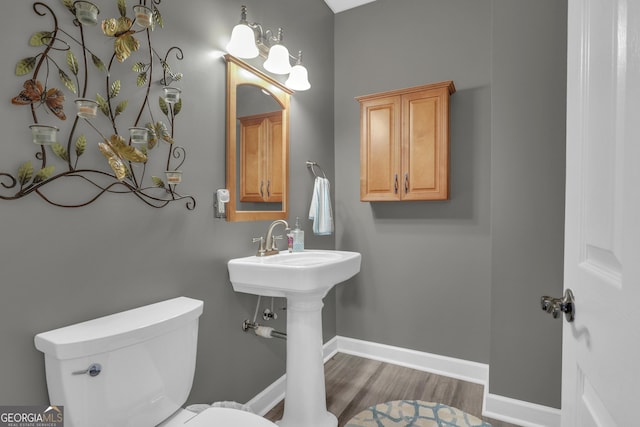 bathroom featuring hardwood / wood-style floors and toilet