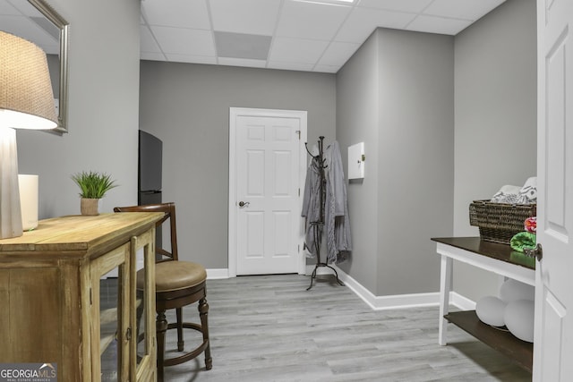 interior space featuring light hardwood / wood-style flooring and a drop ceiling