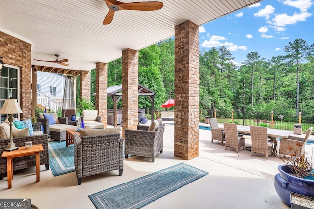 view of patio featuring outdoor lounge area, a gazebo, and ceiling fan