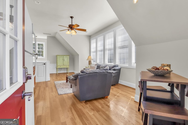 living room featuring hardwood / wood-style flooring, vaulted ceiling, and ceiling fan