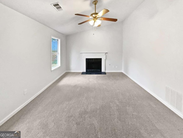 unfurnished living room featuring ceiling fan, carpet, and vaulted ceiling