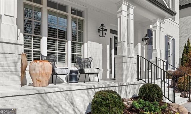 exterior space featuring a porch and brick siding