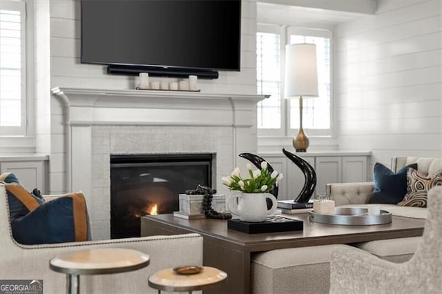 interior space with a wealth of natural light and a glass covered fireplace