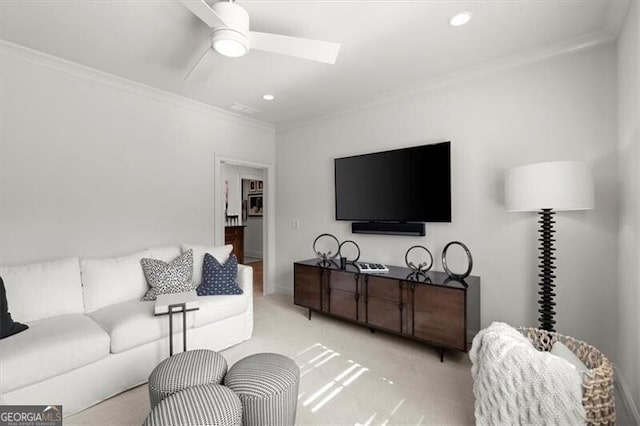 living room featuring ornamental molding, carpet, and a ceiling fan