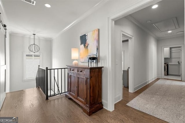 hall featuring crown molding, recessed lighting, a barn door, an upstairs landing, and wood finished floors