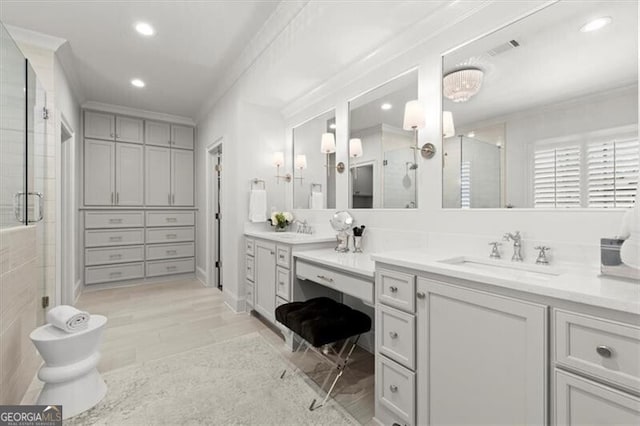 bathroom with ornamental molding, recessed lighting, a shower stall, and vanity