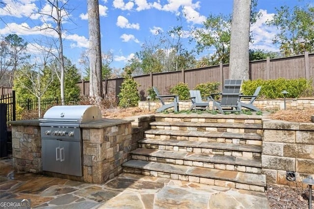 view of patio / terrace featuring a fenced backyard and area for grilling