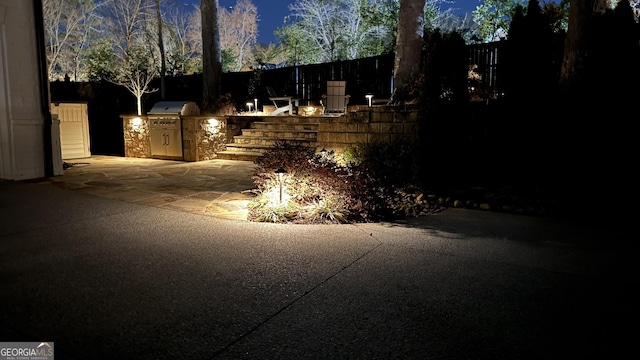 view of patio / terrace featuring an outdoor kitchen, fence, and grilling area