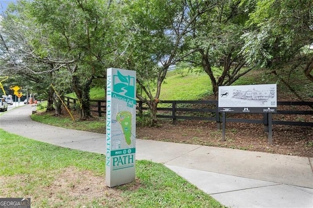 surrounding community featuring a lawn and fence