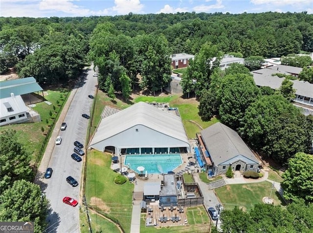 drone / aerial view featuring a wooded view