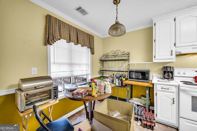 kitchen featuring light countertops, electric range, stainless steel microwave, and white cabinets