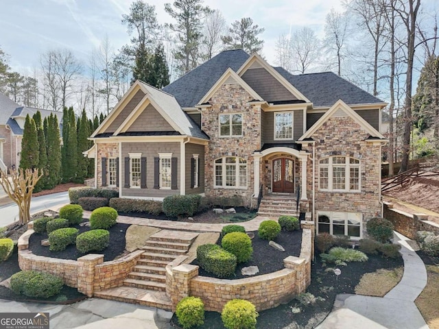 craftsman inspired home featuring stone siding and french doors