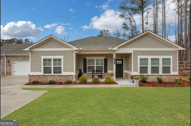 craftsman house featuring brick siding, a front lawn, and covered porch