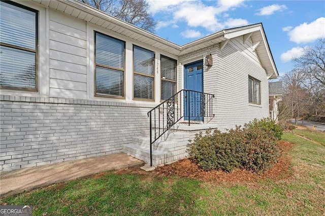 doorway to property with brick siding