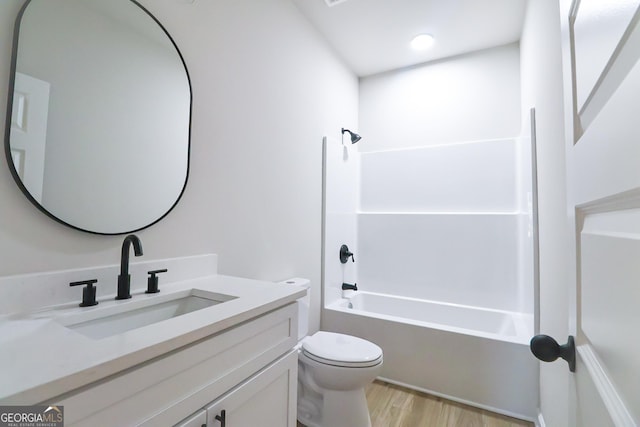 full bathroom with vanity, shower / bath combination, wood finished floors, and toilet