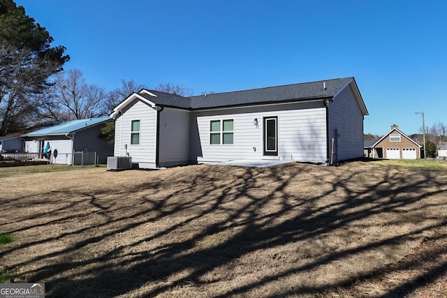 back of property with fence, central AC, a lawn, and a patio