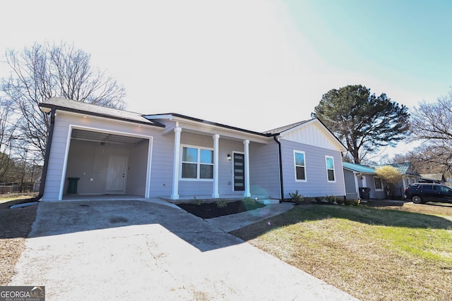 ranch-style house with a garage, board and batten siding, driveway, and a front lawn