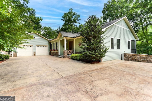 single story home featuring a garage and concrete driveway