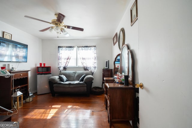 bedroom with a ceiling fan and dark wood finished floors