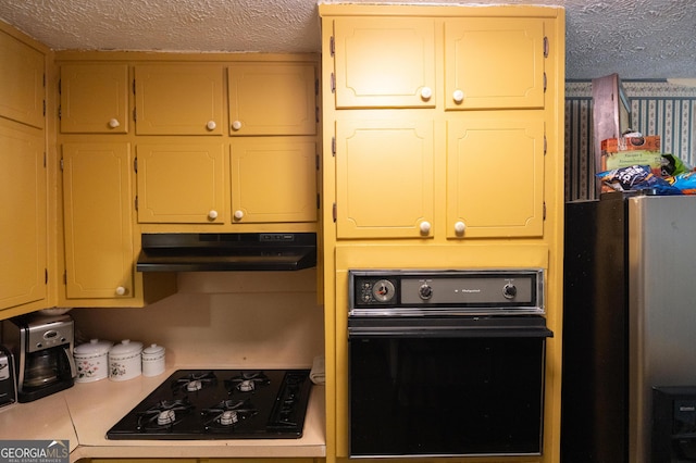 kitchen featuring under cabinet range hood, black appliances, light countertops, and a textured ceiling