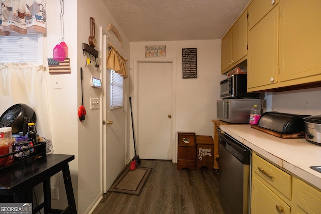 kitchen with light countertops, a textured ceiling, dark wood-type flooring, and appliances with stainless steel finishes