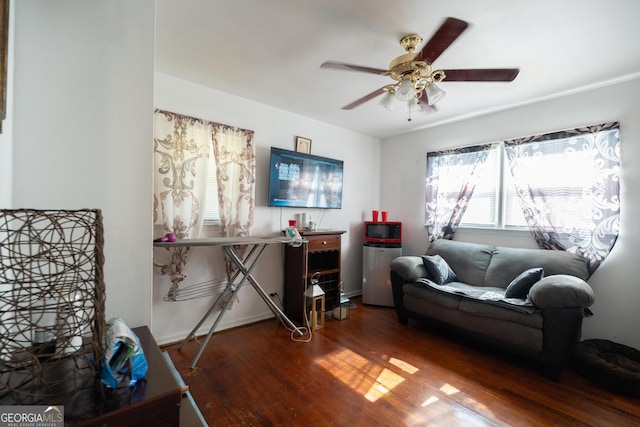 living area with ceiling fan and wood finished floors