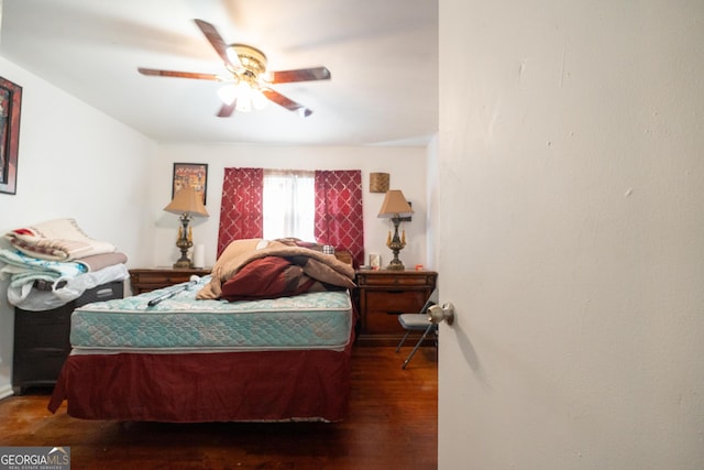 bedroom with ceiling fan and dark wood-style floors