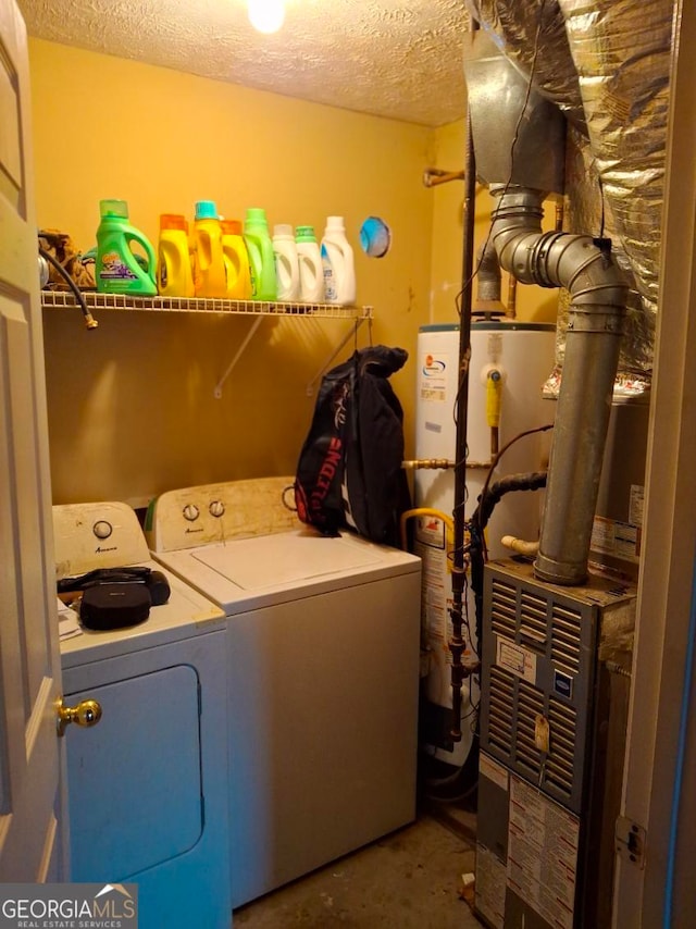 laundry room with laundry area, washing machine and clothes dryer, a textured ceiling, and gas water heater