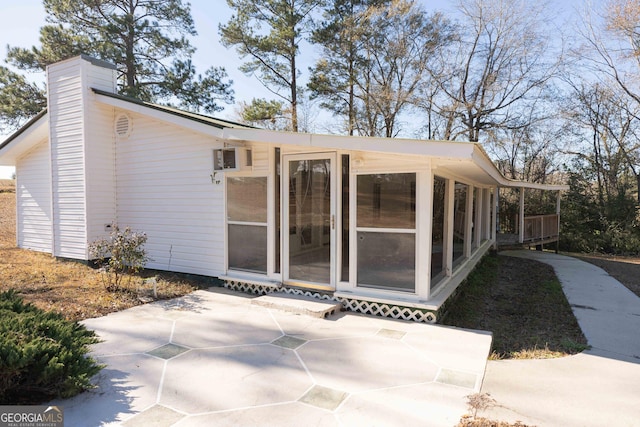 exterior space with a patio and a chimney