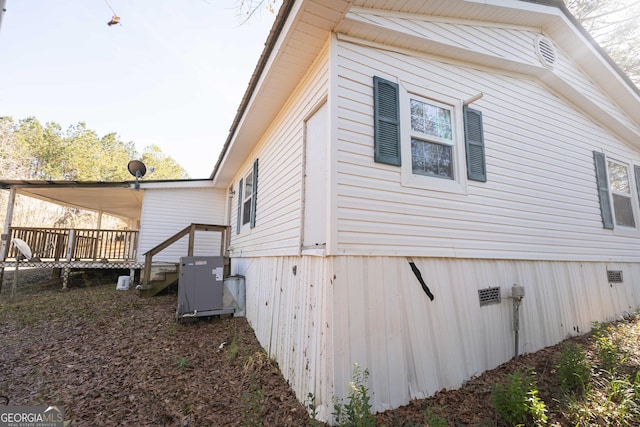 view of side of property featuring a wooden deck and crawl space