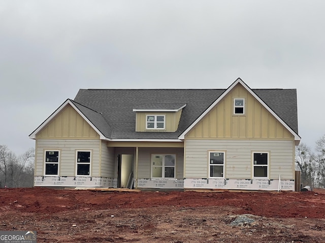 view of front of property with a shingled roof and board and batten siding