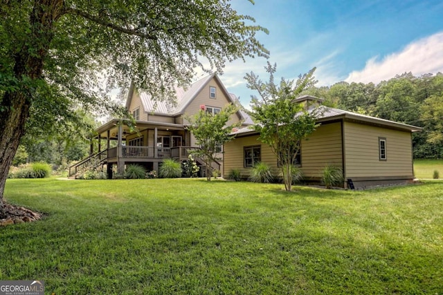 153 Falls Creek Dr, Hiawassee, GA 30546 - rear view of property with a yard, a metal roof, and stairway