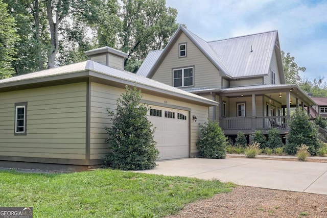 153 Falls Creek Dr, Hiawassee, GA 30546 - view of front of home with driveway, covered porch, an attached garage, and a metal roof