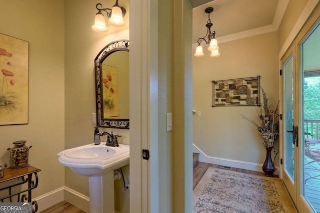 153 Falls Creek Dr, Hiawassee, GA 30546 - bathroom with a chandelier, wood finished floors, and ornamental molding