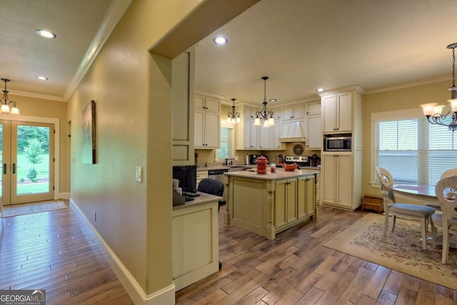 153 Falls Creek Dr, Hiawassee, GA 30546 - kitchen with a chandelier, premium range hood, appliances with stainless steel finishes, crown molding, and hardwood / wood-style floors