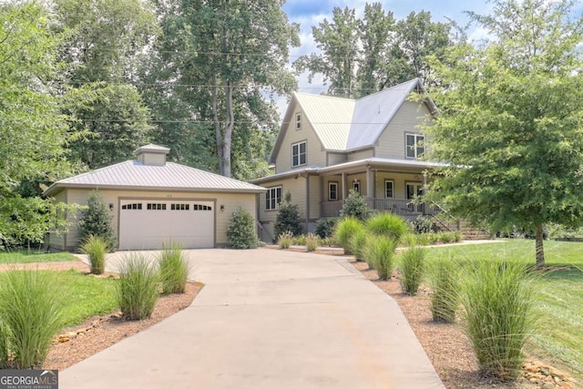 153 Falls Creek Dr, Hiawassee, GA 30546 - view of front of property featuring covered porch, concrete driveway, a metal roof, and a garage