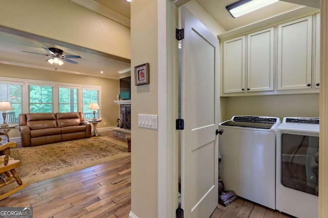 153 Falls Creek Dr, Hiawassee, GA 30546 - laundry area featuring washer and dryer, light wood-style floors, a ceiling fan, cabinet space, and a fireplace