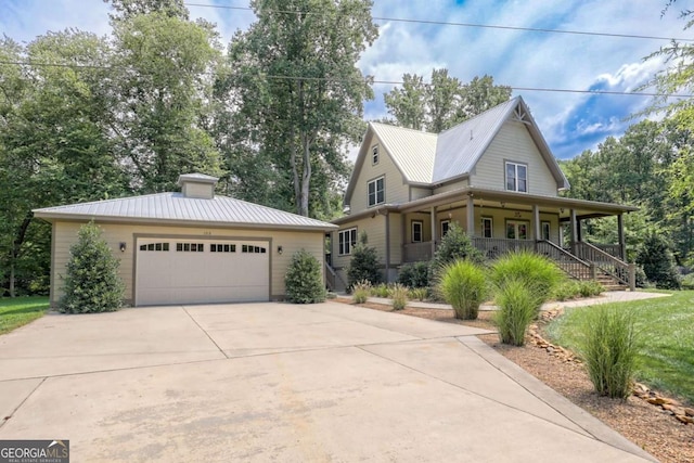 153 Falls Creek Dr, Hiawassee, GA 30546 - view of front of property featuring covered porch, driveway, an attached garage, a metal roof, and a chimney