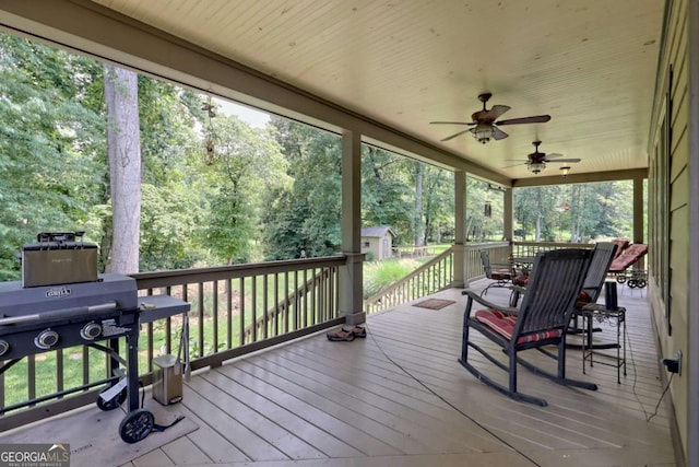 153 Falls Creek Dr, Hiawassee, GA 30546 - deck with a storage shed, ceiling fan, area for grilling, and view of scattered trees