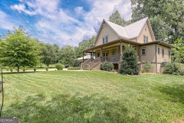 153 Falls Creek Dr, Hiawassee, GA 30546 - view of side of property featuring a porch, a lawn, and a metal roof