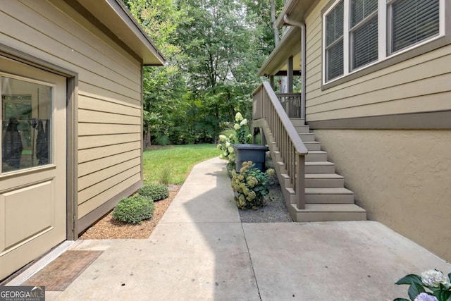 153 Falls Creek Dr, Hiawassee, GA 30546 - view of exterior entry with a patio and view of wooded area